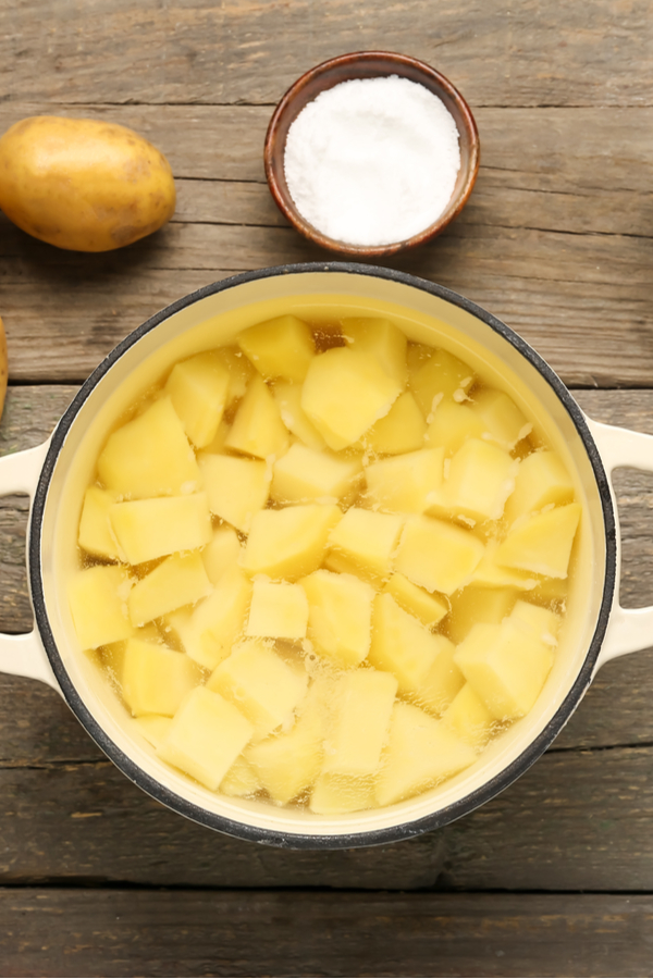 peeled and cubed potatoes in pot full of water