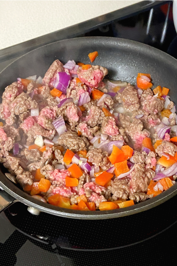ground beef cooking in a skillet 