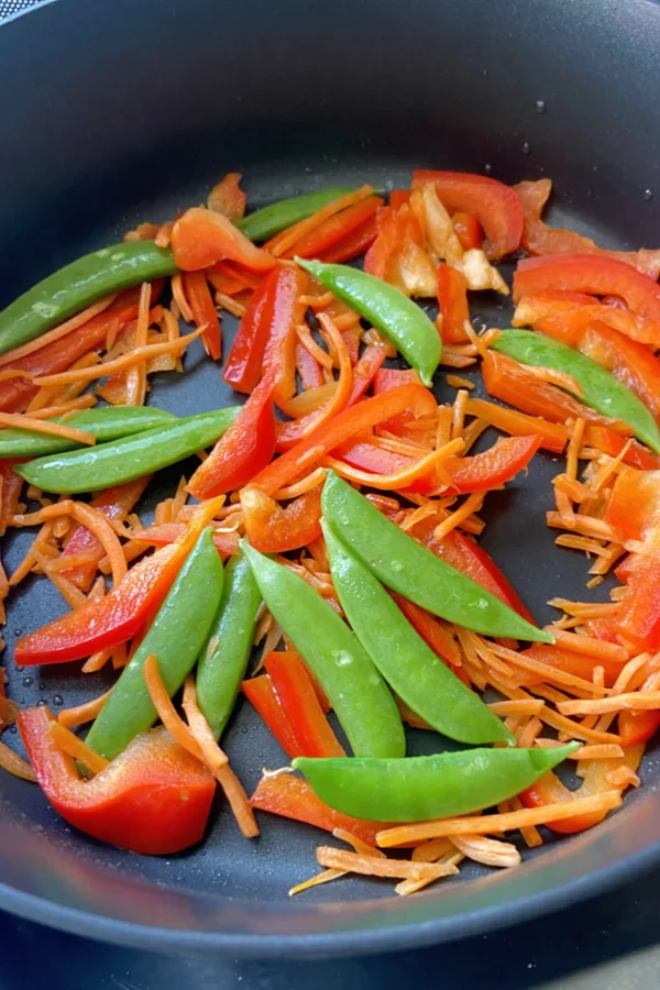saute red pepper, sugar snap peas and carrots