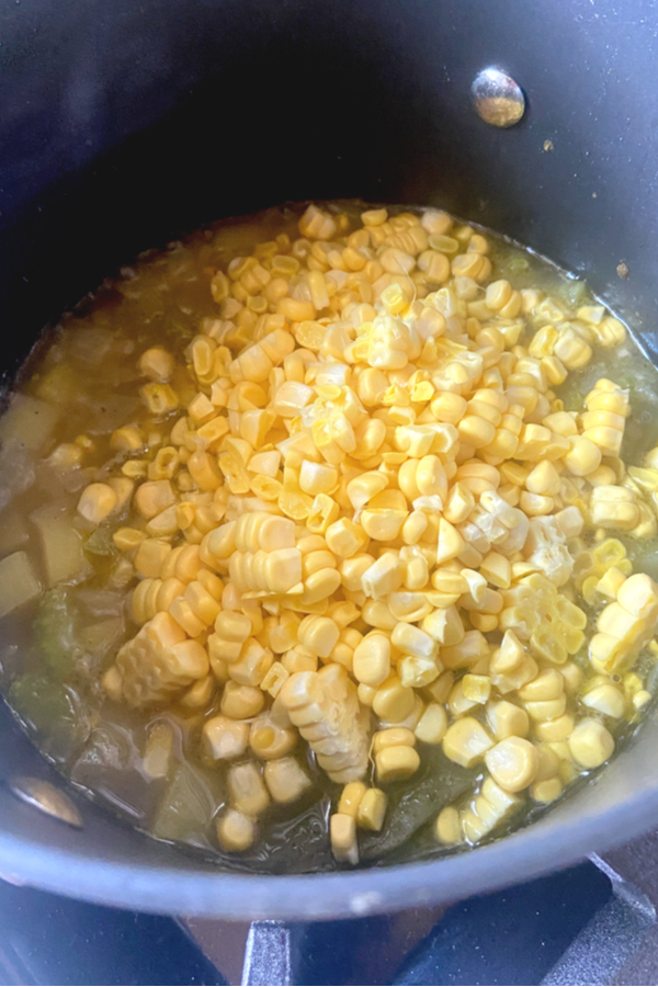 corn added to broth and potatoes