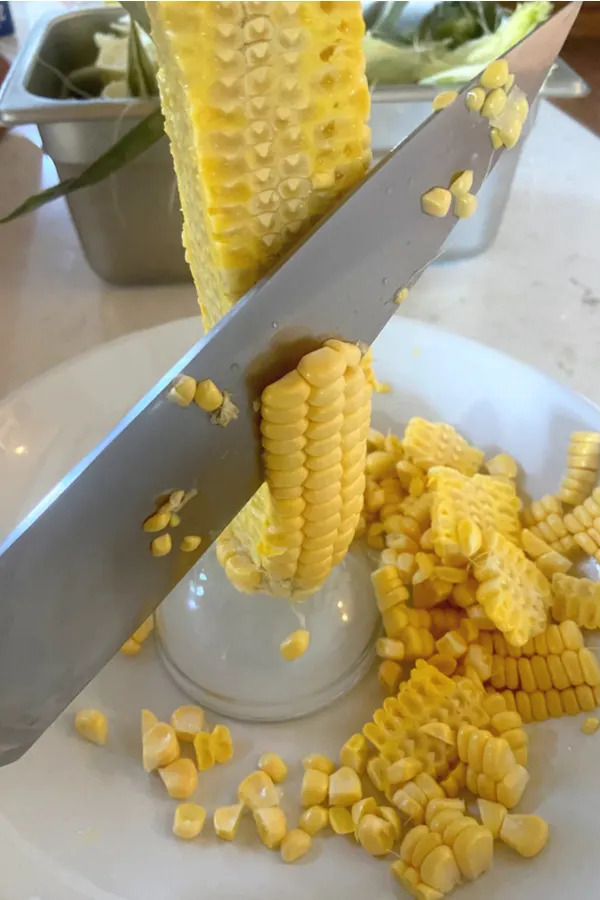 fresh corn being cut off the cob