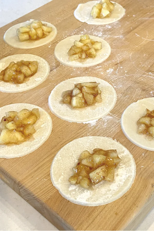 apple pie filling in the center of circle pie crusts to make Baked Apple Hand Pies