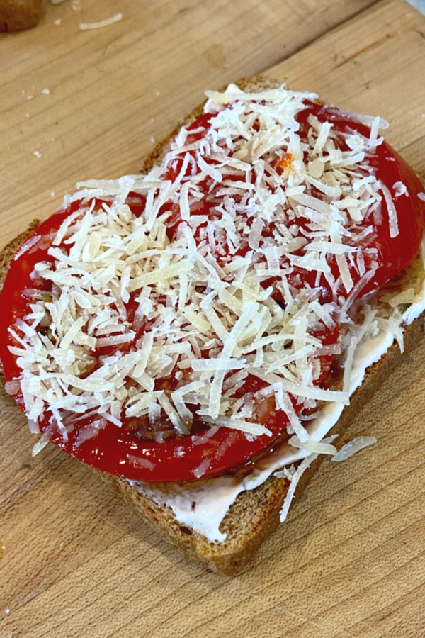 Parmesan cheese on top of slices of tomatoes