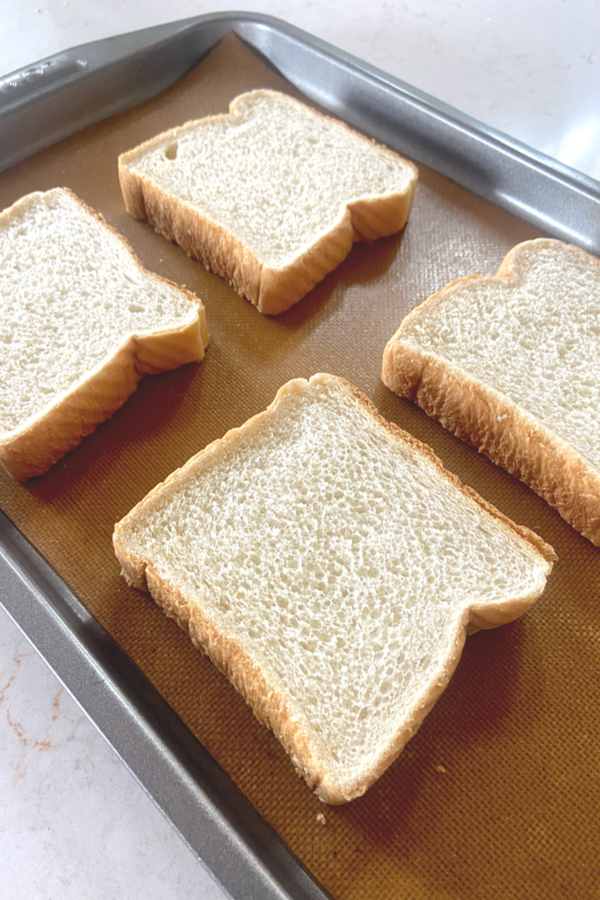 Texas toast on a sheet pan lined with silicone