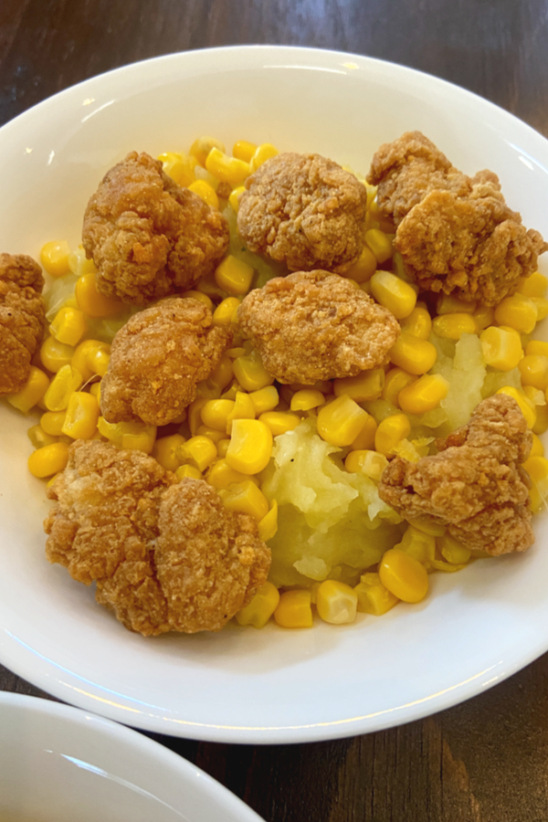 popcorn chicken mashed potatoes and corn in a bowl