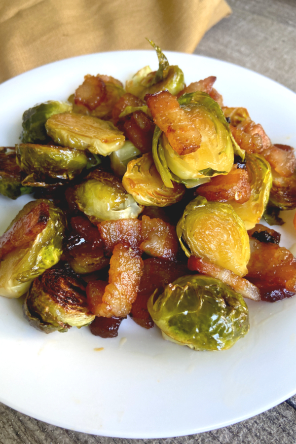 best roasted Brussels spouts with bacon on a white plate