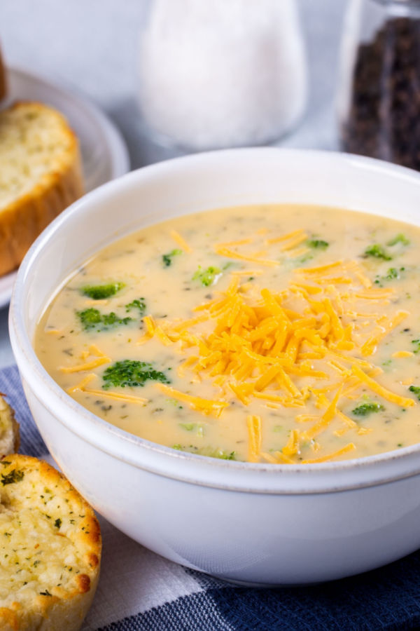 bowl of broccoli cheddar soup topped with shredded cheese