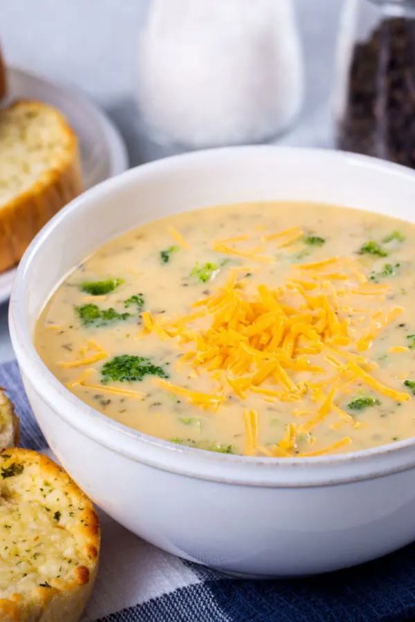 bowl of broccoli cheddar soup topped with shredded cheese