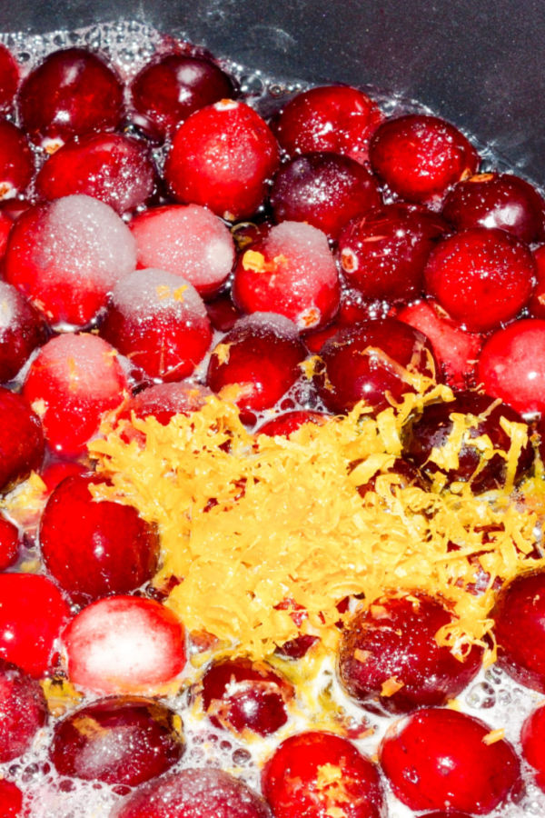 cranberries in a pot with sugar and orange zest 