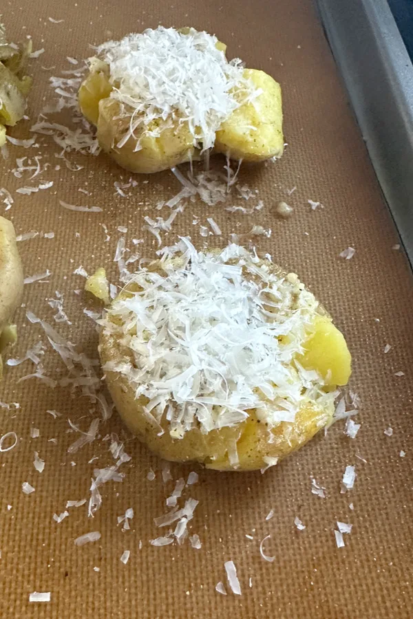 Parmesan cheese sprinkled on garlic smashed potatoes