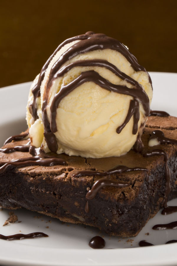 chocolate brownie topped with ice cream the ultimate dessert for two