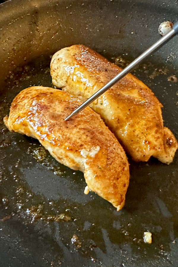 seasoned chicken in skillet 