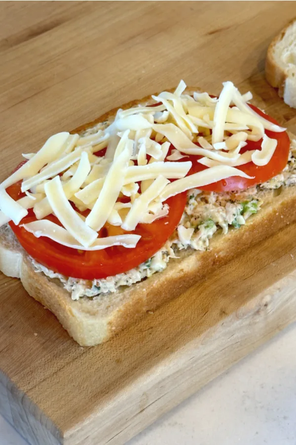 shredded cheese tomato on sandwich