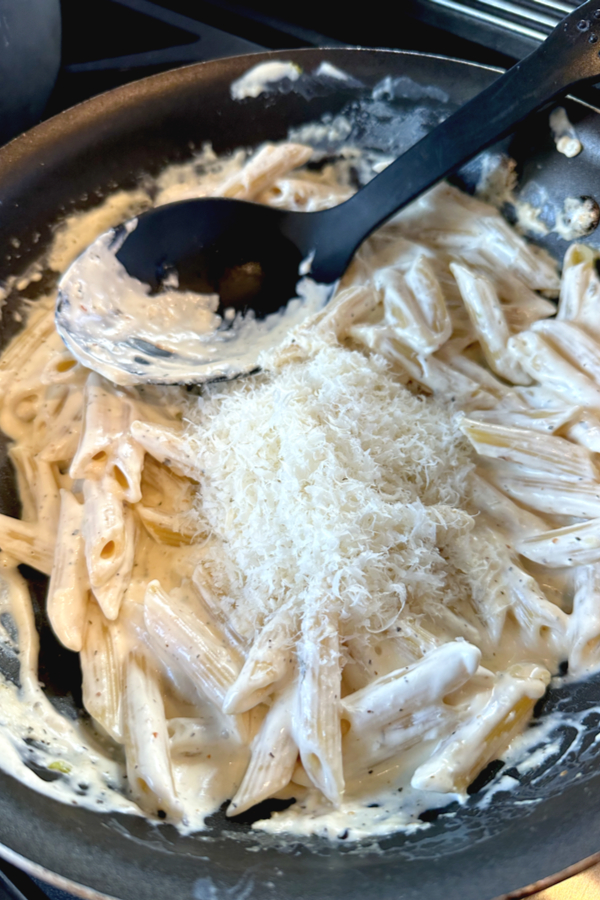 Parmesan cheese over creamy pasta