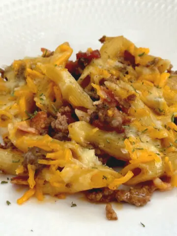 bacon cheeseburger pasta on white plate