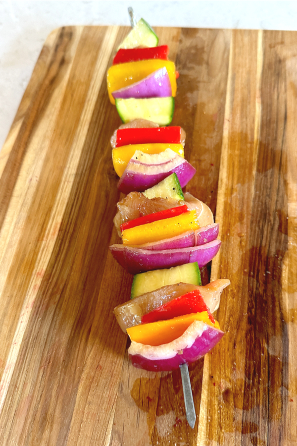 skewer filled with colorful vegetables and chicken chunks