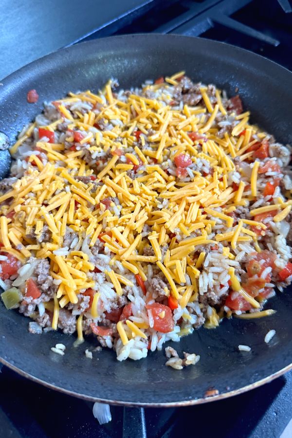 shredded cheese on beef and rice mixture 