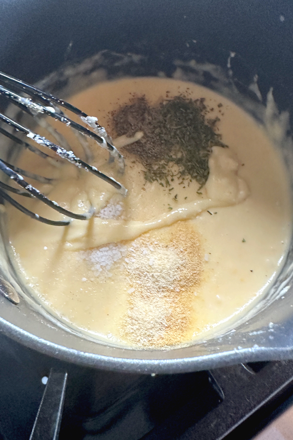 making homemade cream of chicken soup in a sauce pan