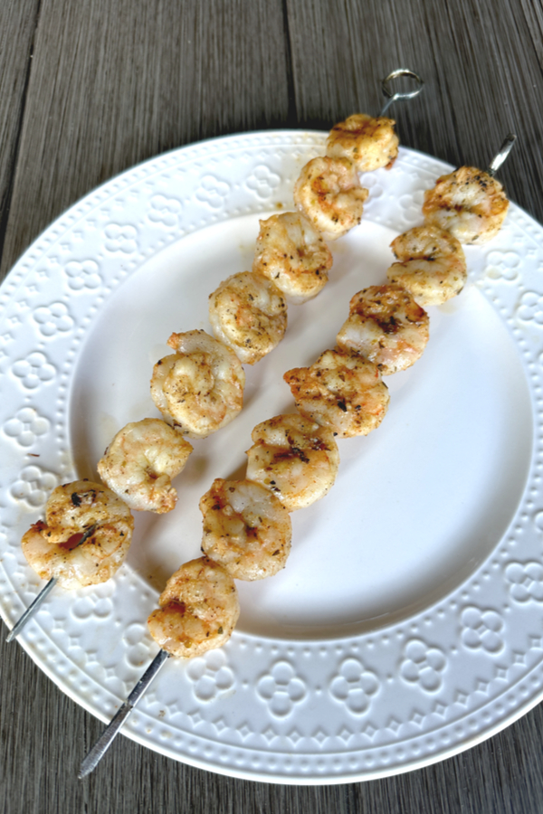 grilled shrimp skewers on a white plate