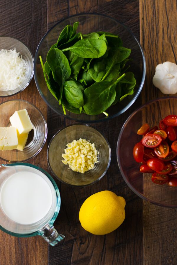 fresh ingredients - spinach, tomatoes, butter, garlic, cheese, cream, lemon