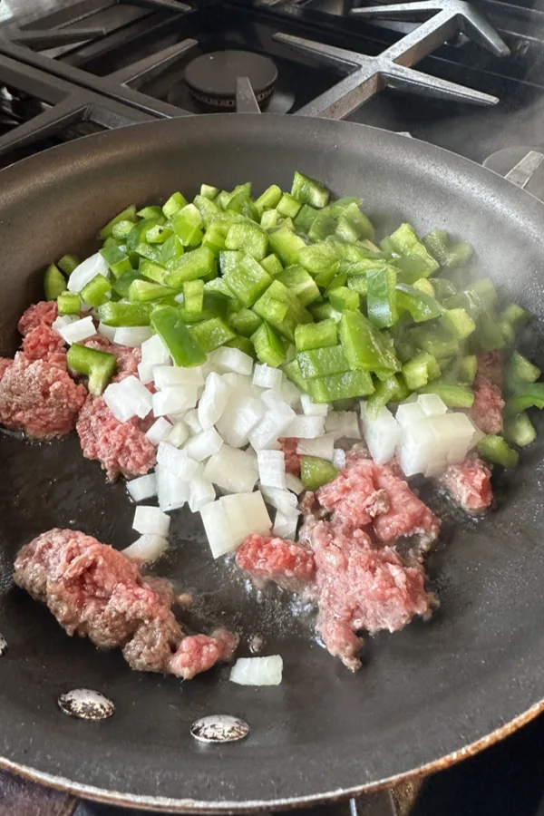 ground beef, onions, green pepper in skillet 
