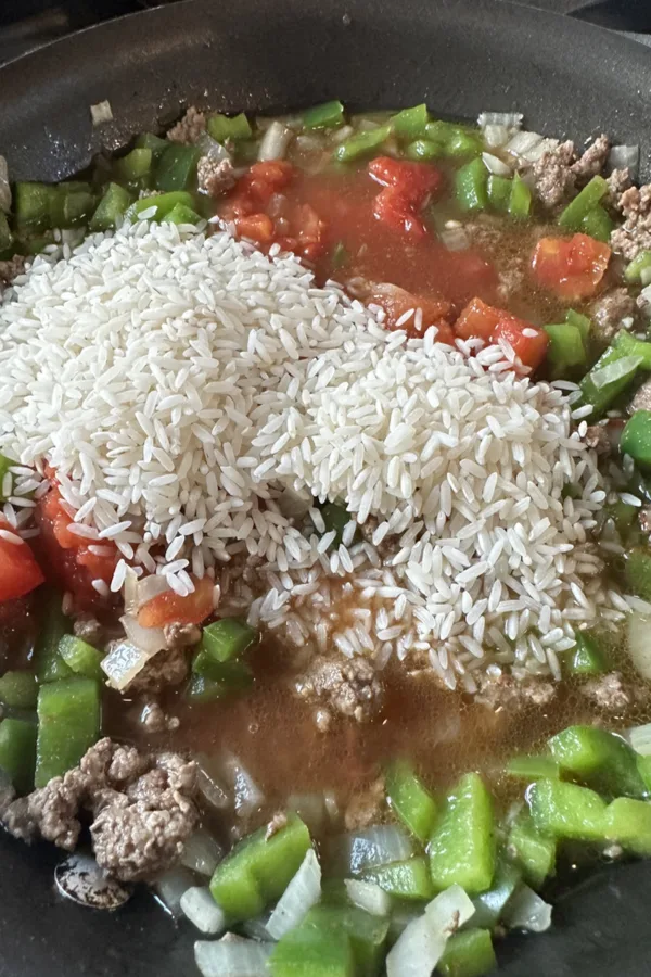 rice and tomatoes in skillet 