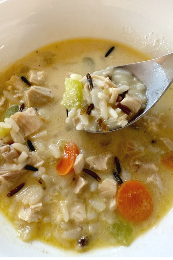 spoon with chicken and wild rice soup 
