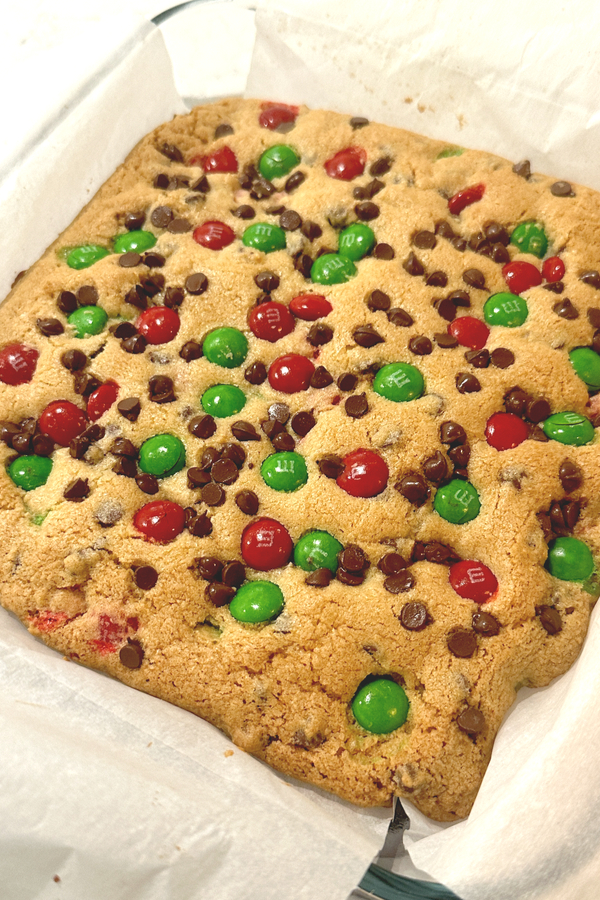 Cooked M&M cookie bars cooling in a sheet pan.
