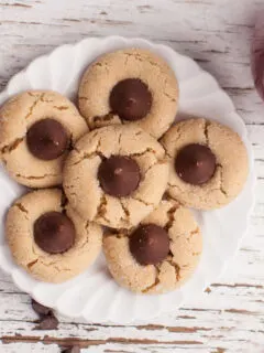 6 peanut butter blossom cookies on a white plate