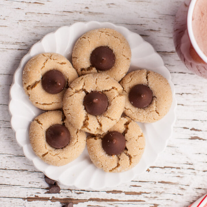 6 peanut butter blossom cookies on a white plate