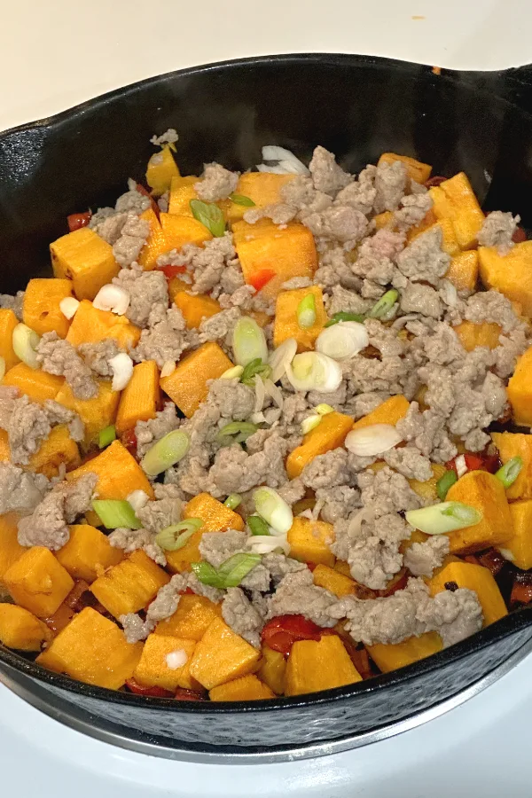 sweet potatoes and sausage in a skillet 