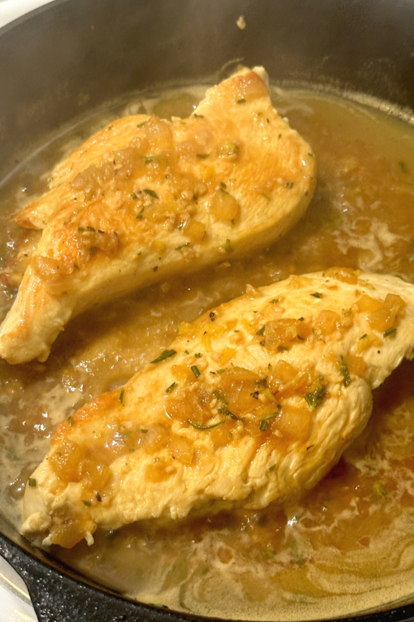chicken in skillet with sauce