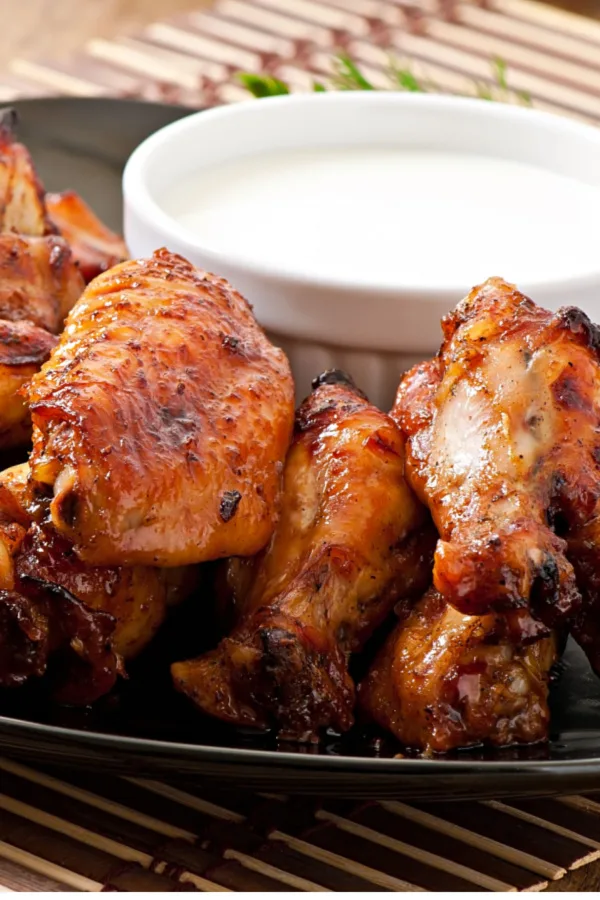 Baked chicken wings with dipping sauce.
