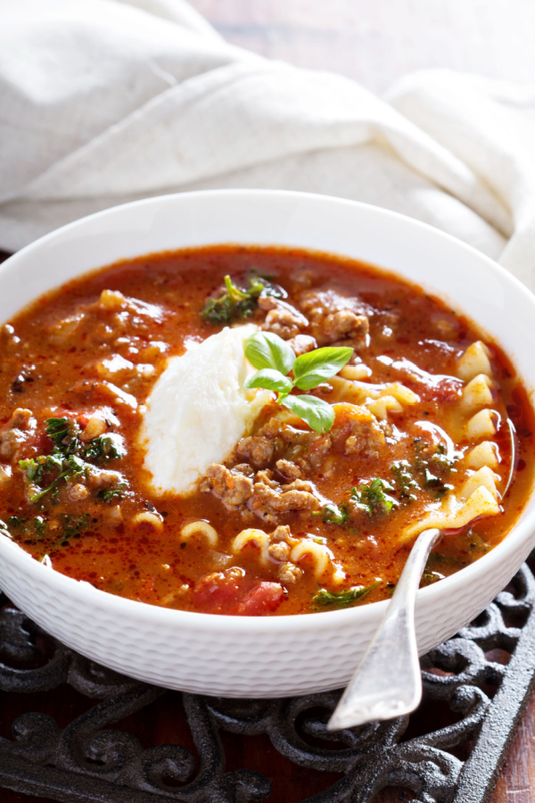 bowl of lasagna soup with cheese topping 