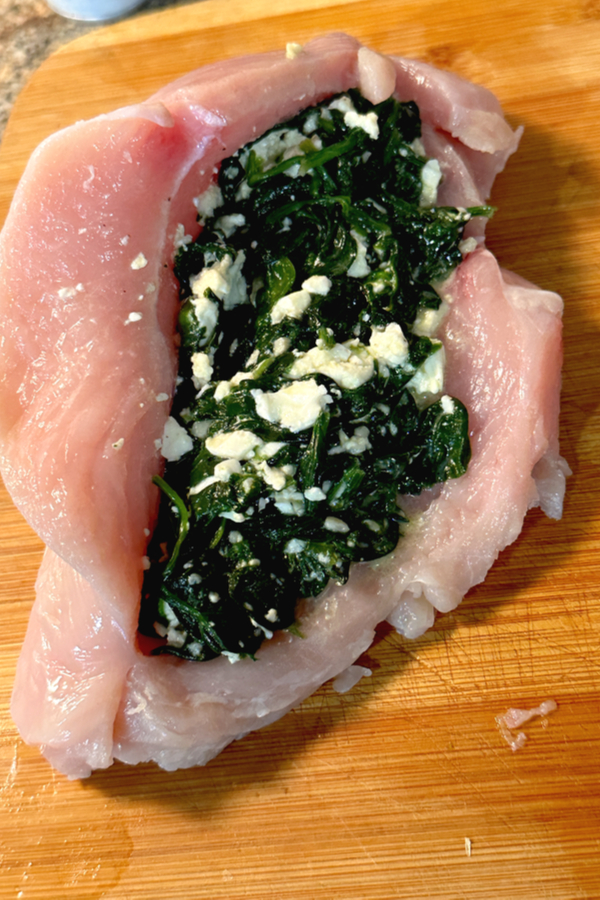 spinach and feta filling stuffed inside chicken breasts