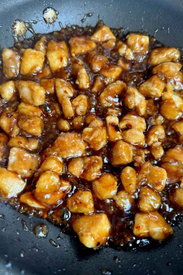 General tso's chicken and sauce in skillet