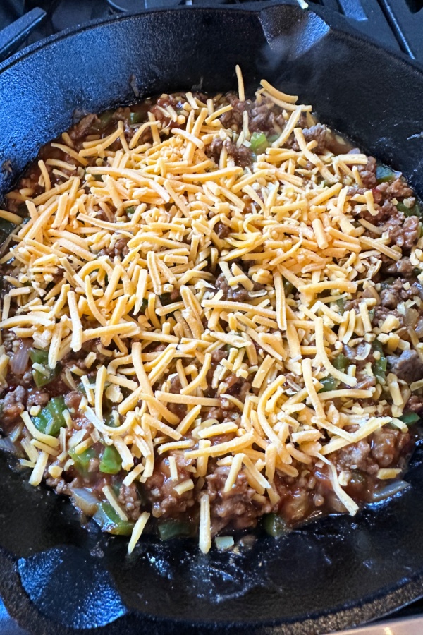 shredded cheese on meat mixture