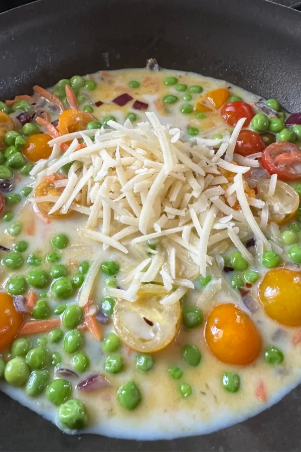 parmesan cheese and vegetables in skillet