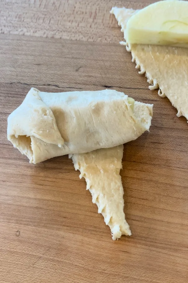 wrapping an apple slice in dough