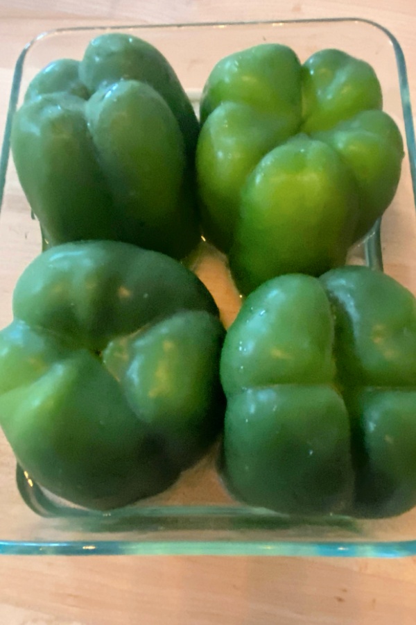 green peppers upside down in baking dish for stuffed peppers