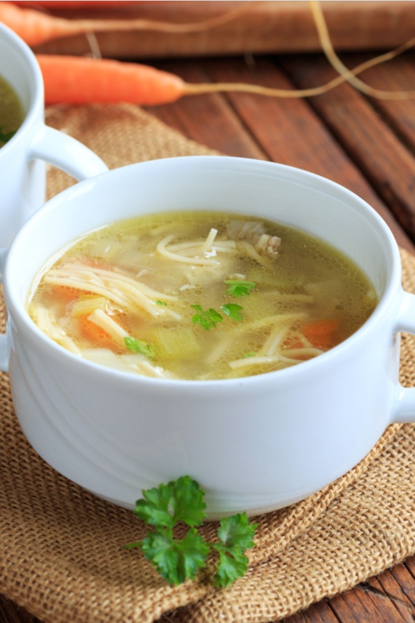 chicken noodle soup in white bowl