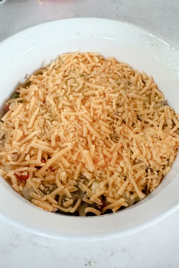 ground beef casserole topped with cheese ready for the oven 