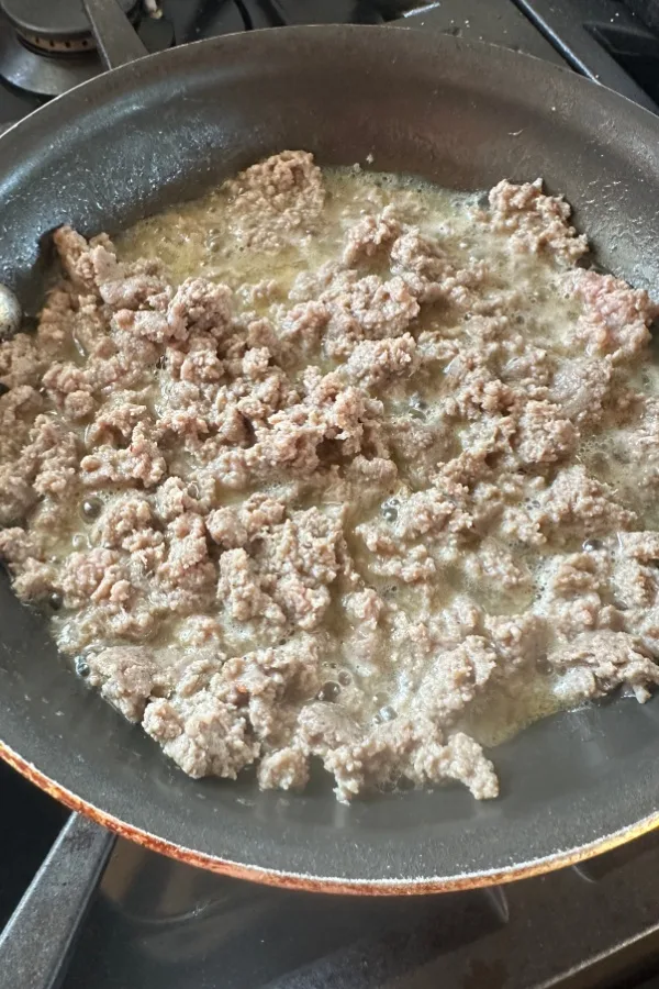 sausage cooking in skillet