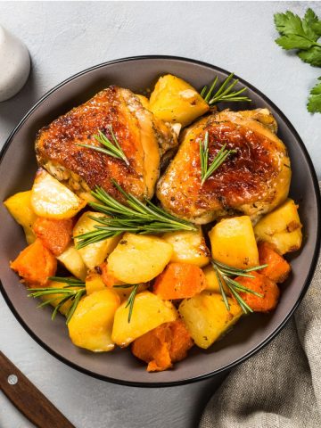 baked chicken thigh and vegetable dinner