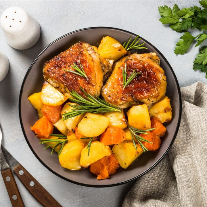 baked chicken thigh and vegetable dinner