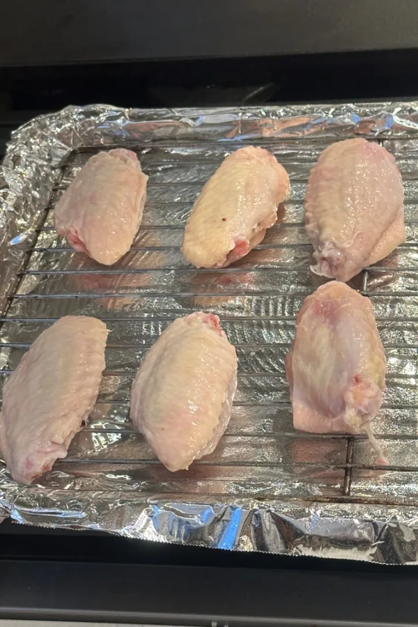 raw wings on baking rack