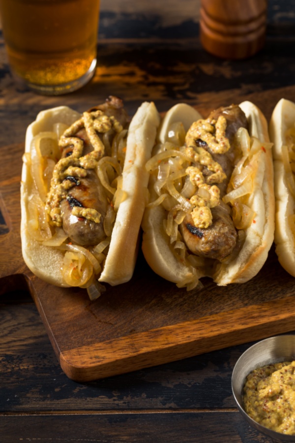 mustard and onion in hot dog bun